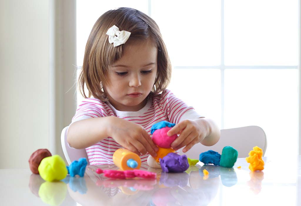 Children playing with blocks and animal figurines